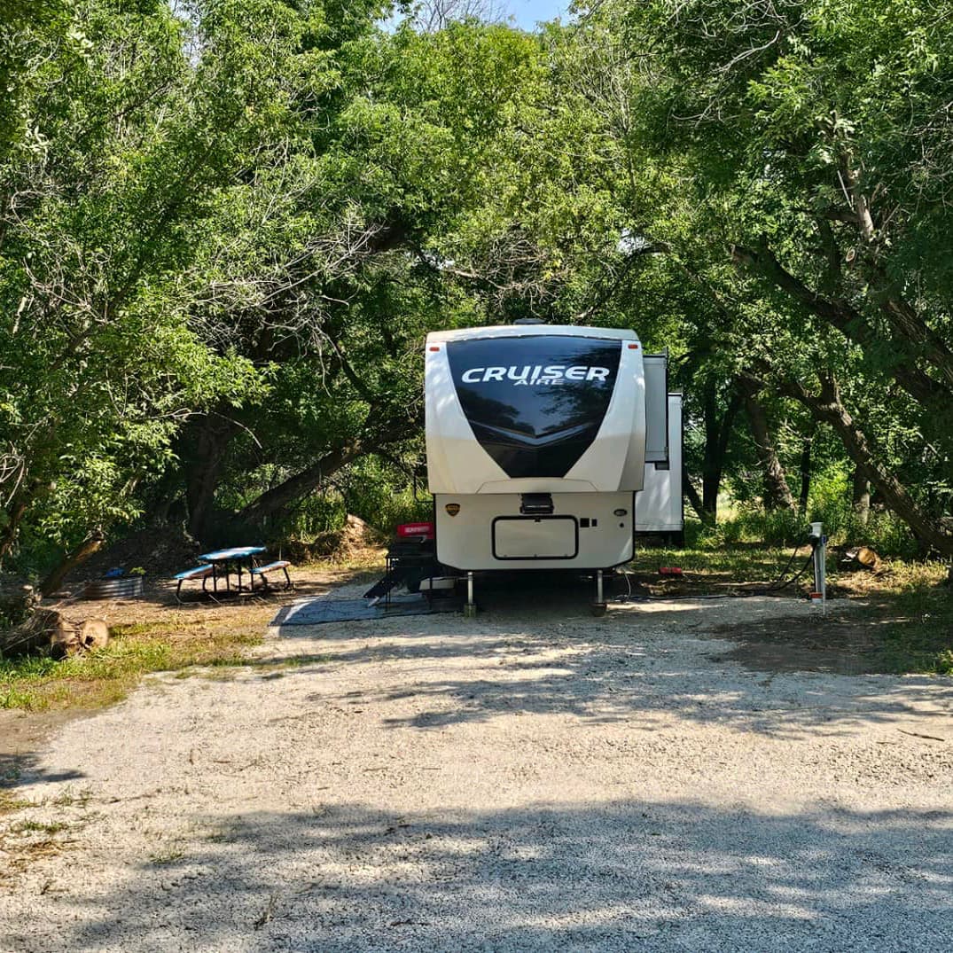 Photo of a campsite with a fifth-wheel RV set up